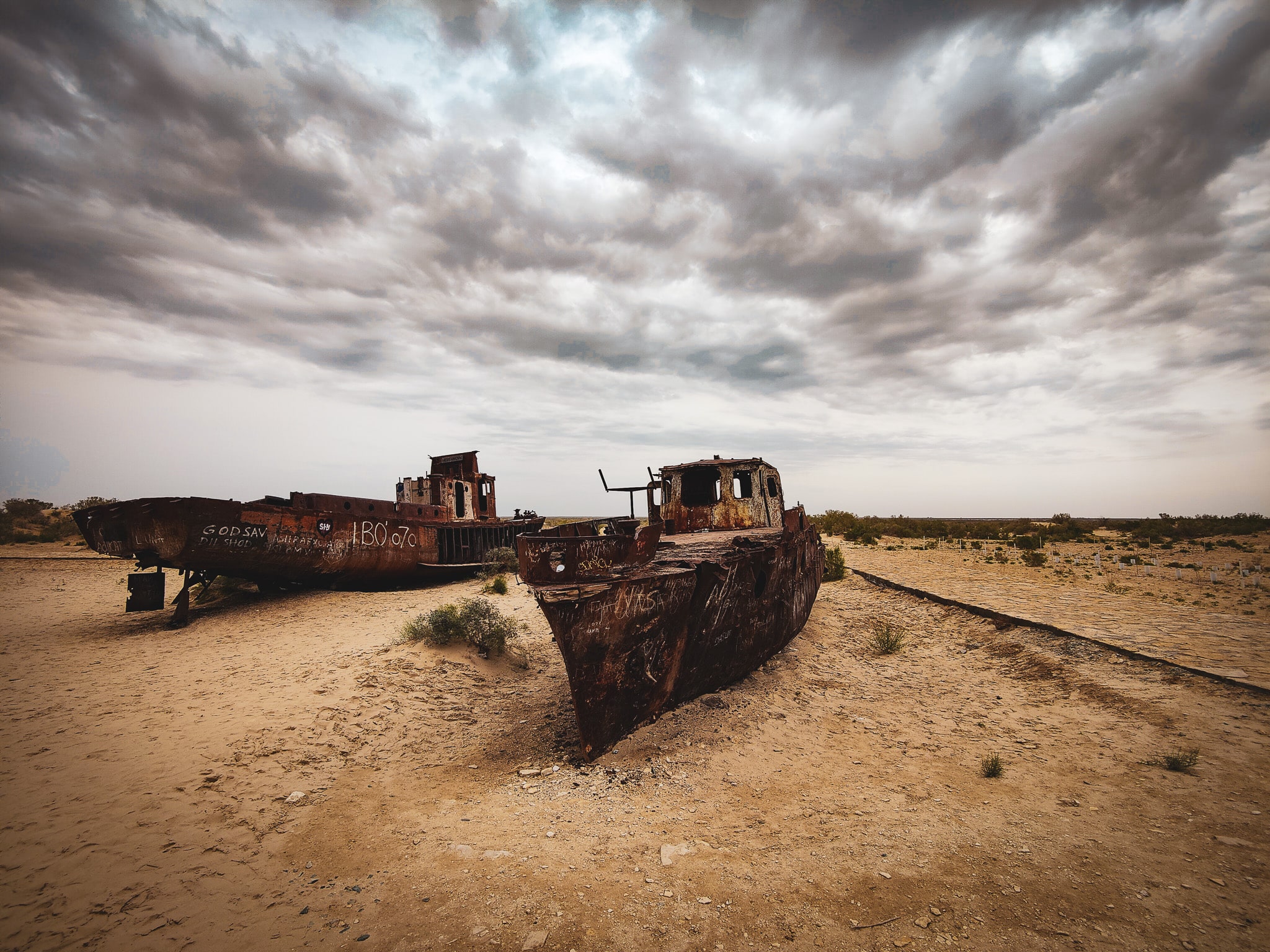 Uzbekistan - Aral Sea - 2 former fishing boats rusting away at Ship Cemetery of Moynaq